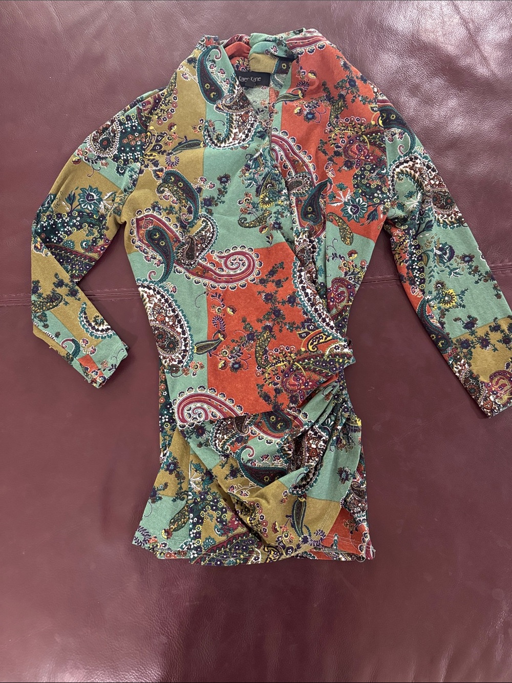 Karen Kane Patchwork Paisley Wrap Top in shades of green and orange